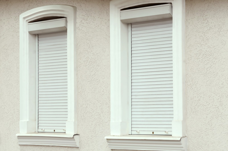 Two windows with rolling shutters